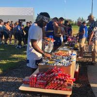 football players lined up to get food